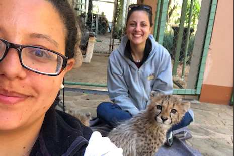 Dr. Ana Bastos and Sarah Abdelmessih with cheetah cub.