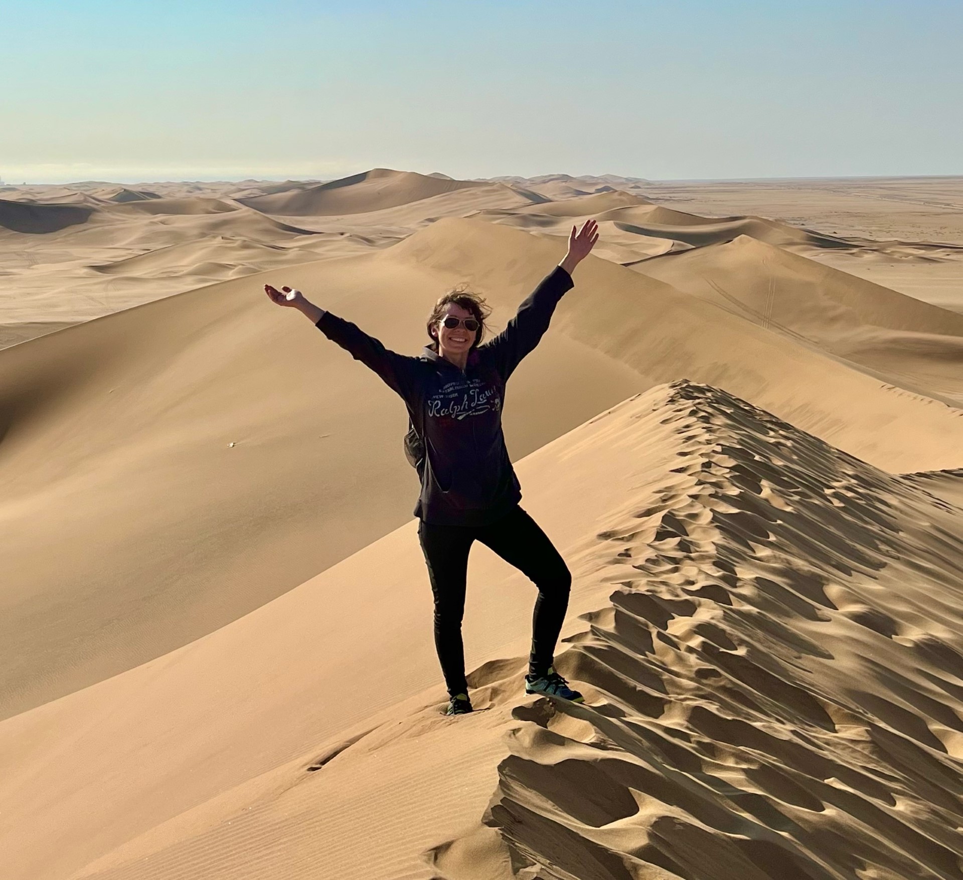 Christine Roviera on top of dunes in Namibia.