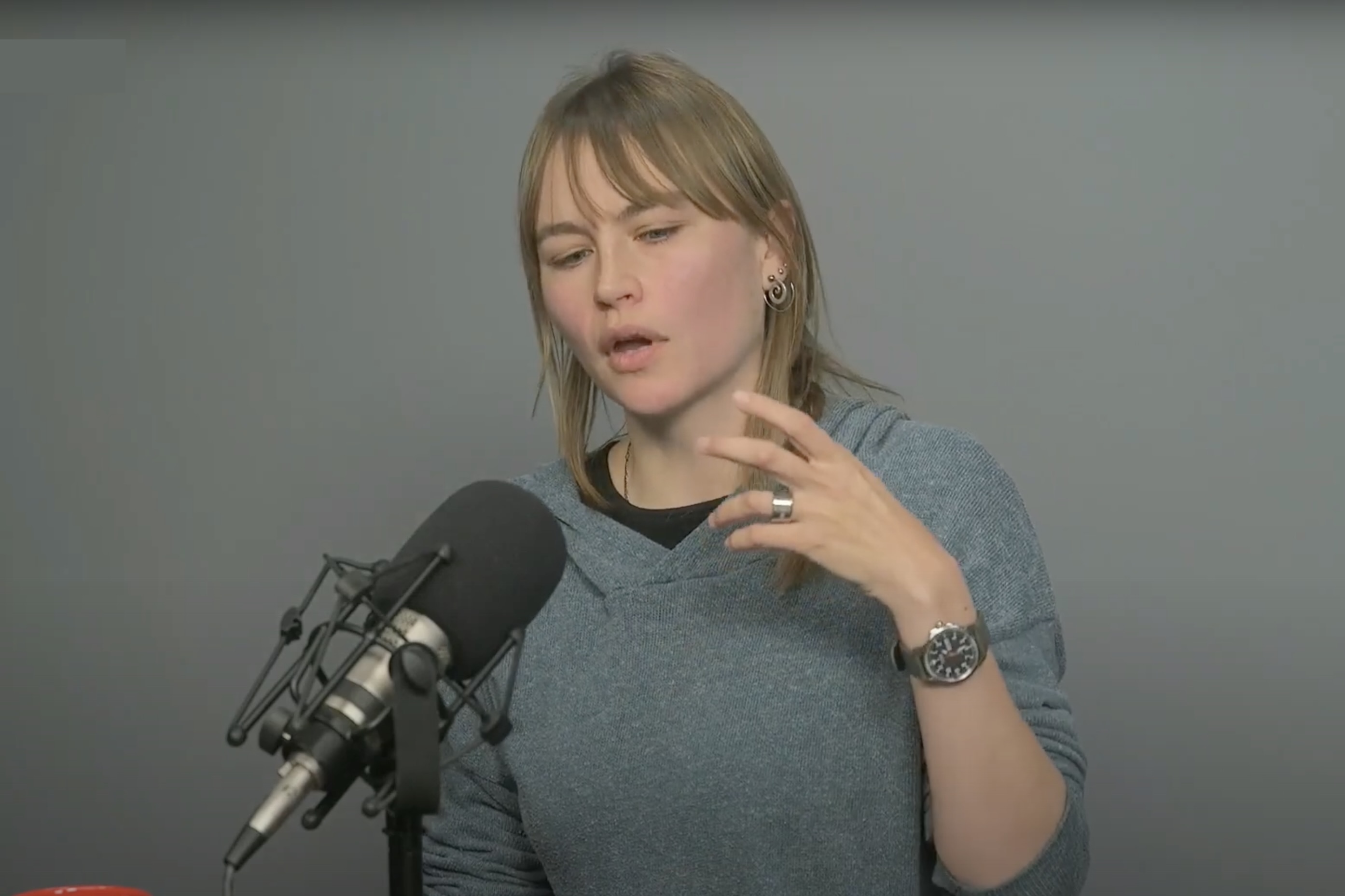 A professor speaking into a microphone