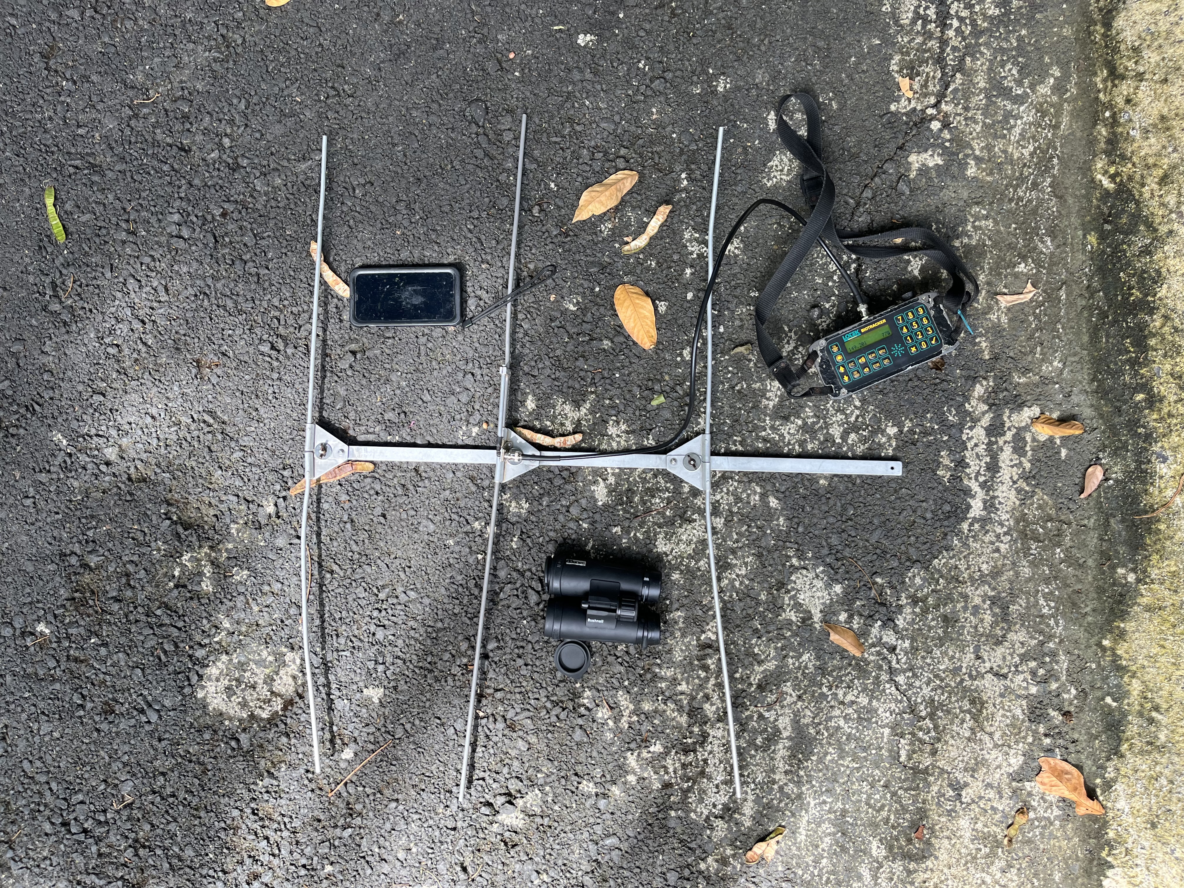 A tracking device laying on the ground.