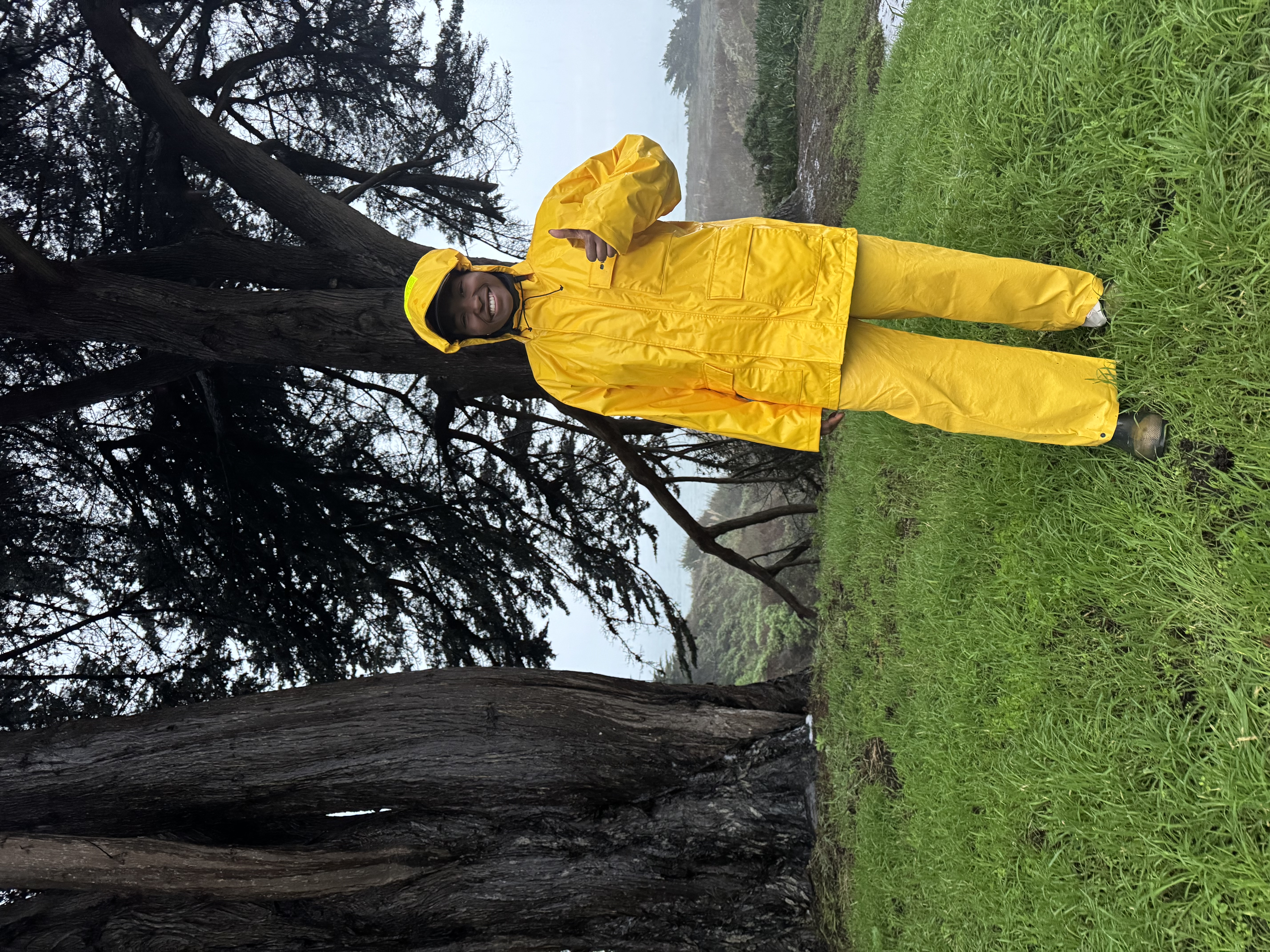 Victoria wearing a yellow rain coat and yellow pants.