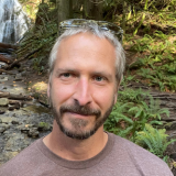 Jan Lovy with waterfall behind him