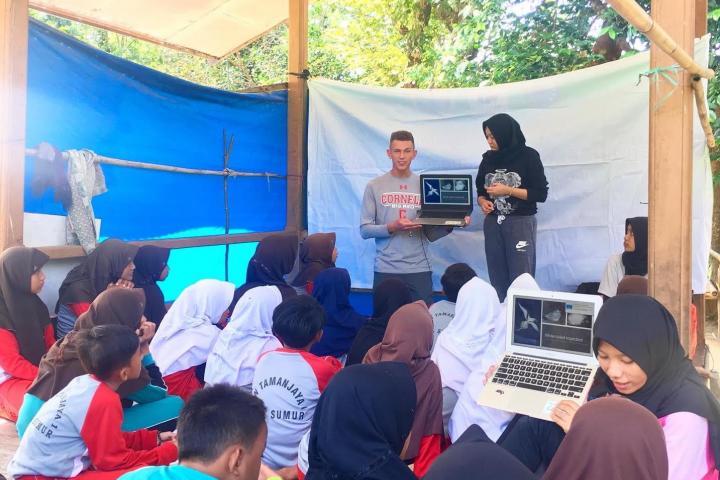 Cornell student teaching children about the role sea birds play in the ecosystem