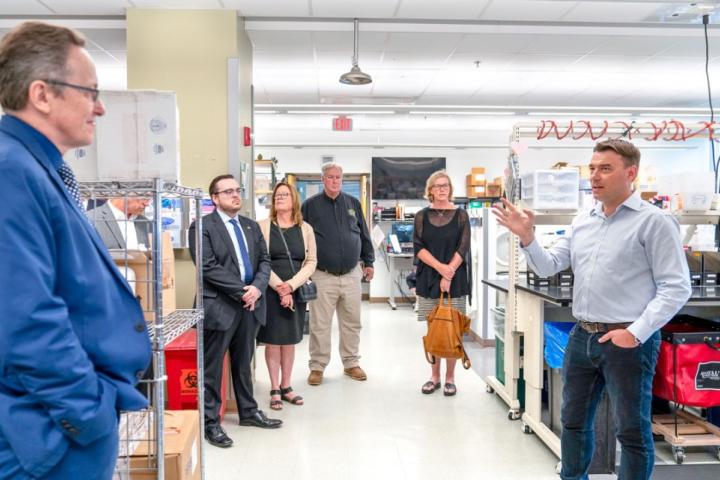Dr. Diego Diel, right, director of the Virology Laboratory, led a tour for attendees before the event by Carol Jennings/CVM