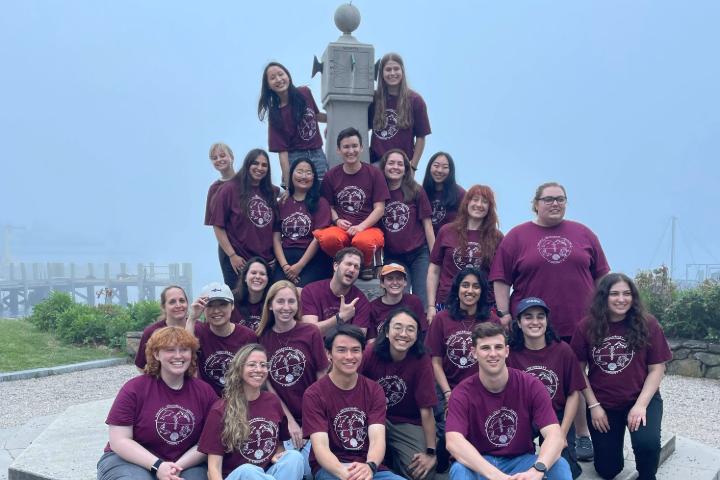 Large group of people smiling at the camera.