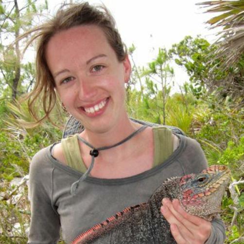 Melissa Fadden holding a lizard in a tropical location