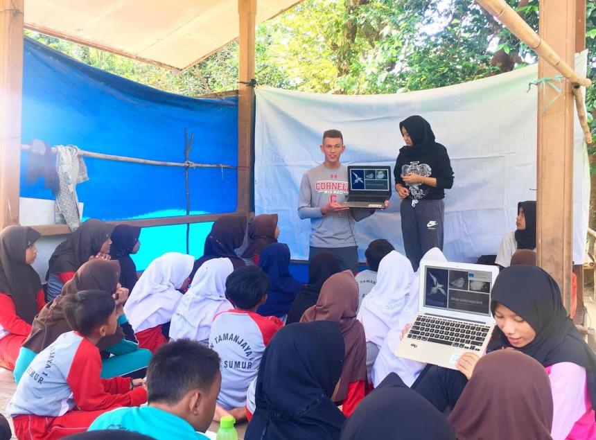 Cornell student teaching children about the role sea birds play in the ecosystem