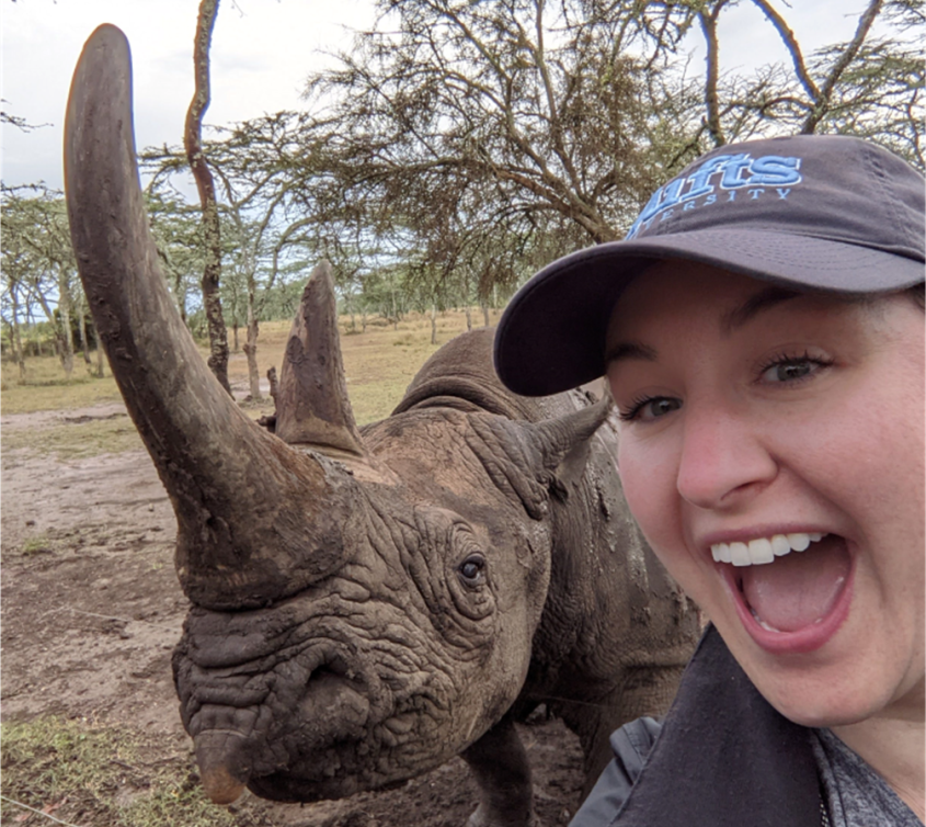 Danielle Sosnicki takes a selfie with a rhino.