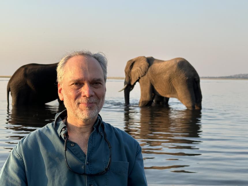 Steve Osofsky standing in front of elephants
