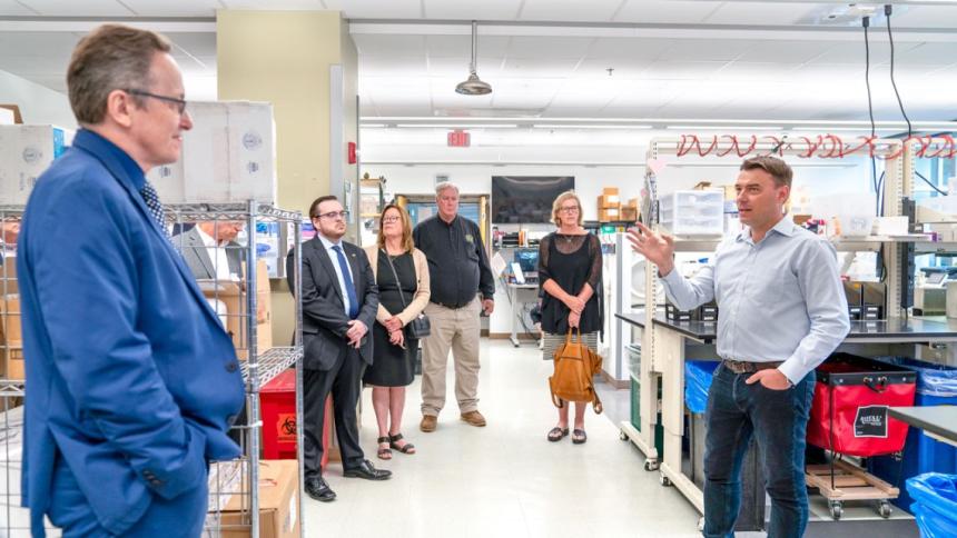 Dr. Diego Diel, right, director of the Virology Laboratory, led a tour for attendees before the event by Carol Jennings/CVM