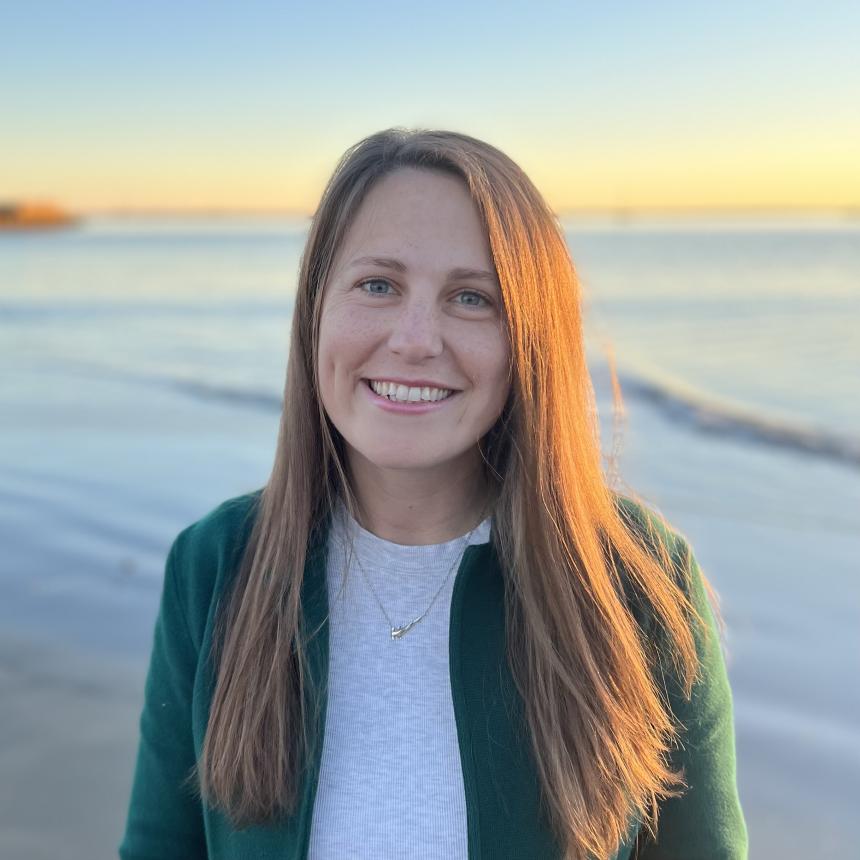 A professional head shot of Kristina Ceres with a beach in the background.